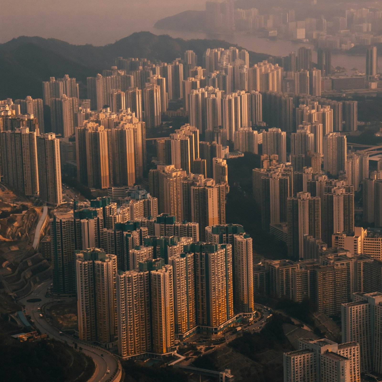 Breathtaking aerial view of Hong Kong's modern skyscrapers and cityscape during sunset, showcasing urban beauty.