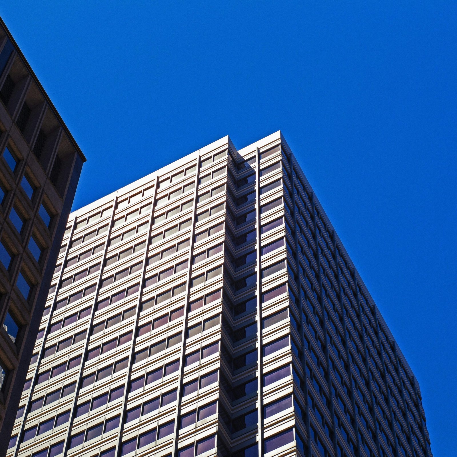 Urban skyscraper in San Francisco with a modern architectural design under a clear blue sky.