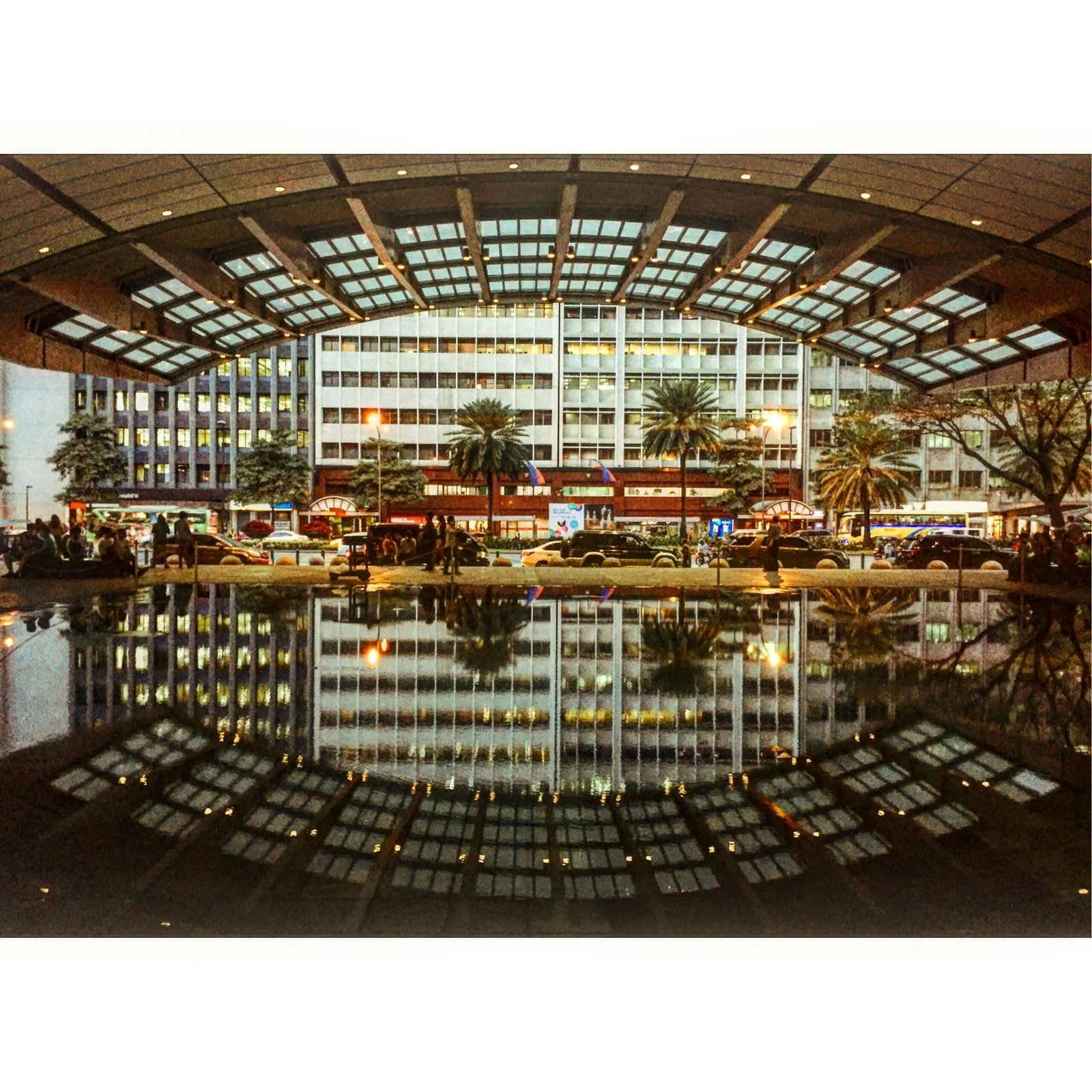 Urban landscape of Makati City with striking building reflections at night.
