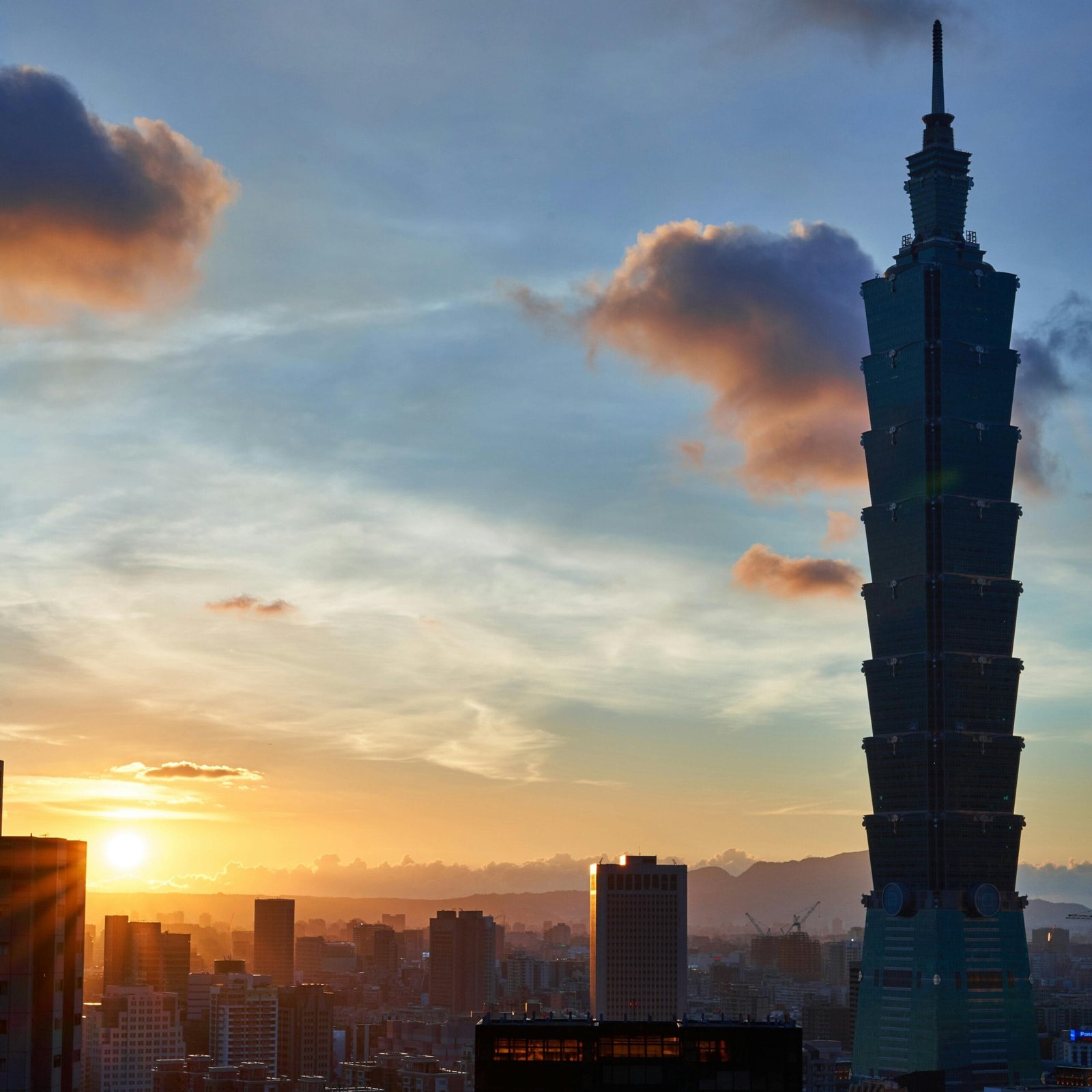 Beautiful sunset view of Taipei 101 towering over the city skyline in Taiwan.