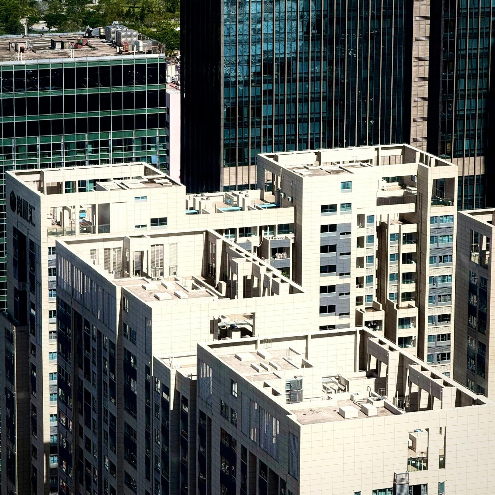 Aerial view of modern skyscrapers with intricate architecture and urban design.