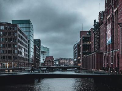 A moody urban scene with a canal and buildings under a gloomy sky in Hamburg, Germany.