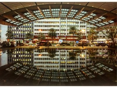 Urban landscape of Makati City with striking building reflections at night.