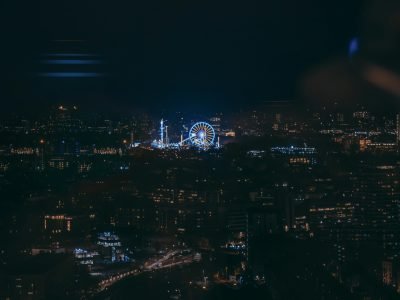 Capture of London's vibrant city lights and ferris wheel at night.