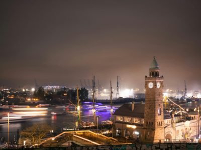 Stunning night view of Landungsbrücken in Hamburg showcasing the lively harbor and iconic clock tower.