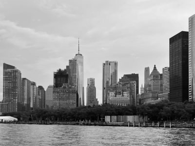 Monochrome view of Manhattan's iconic skyline with towering skyscrapers by the water.