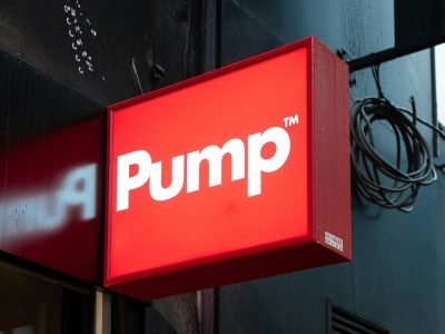 Vibrant red Pump sign on a storefront exterior in Brussels, Belgium.