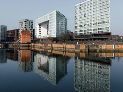 Captivating view of modern buildings reflecting in the water in Hamburg, Germany.