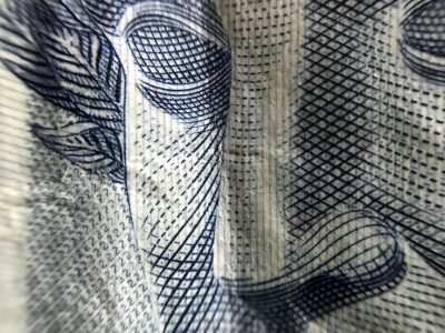 A macro shot showing the intricate design of a Brazilian currency note highlighting texture and detail.
