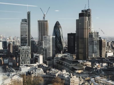 Explore London's modern skyline with iconic skyscrapers, captured from above during the day.