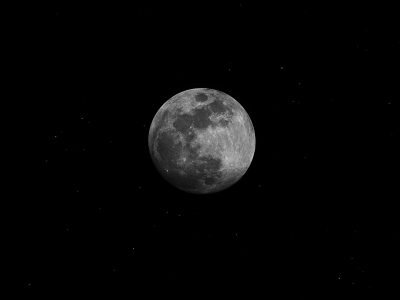 A captivating black and white photo of the full moon against a starry night sky.